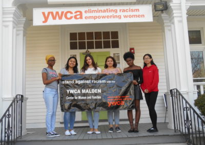 Photo of a group of young women holding a YWCA Malden sign