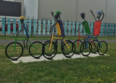 Image of metal art installation of bikes with people on them